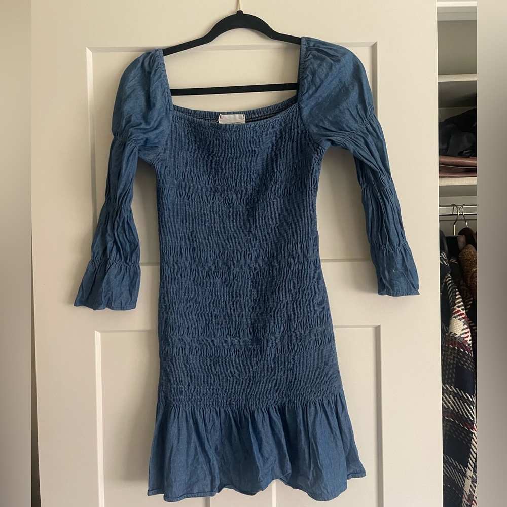 Chambray smocked bodycon dress with ruffle detail. Size small